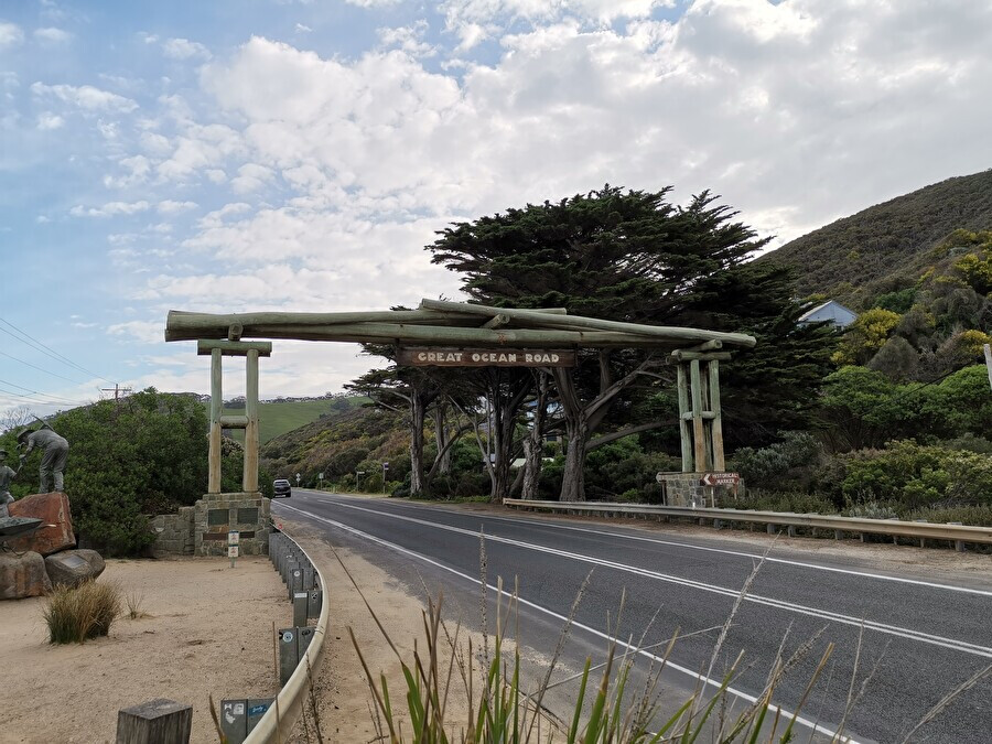 The Great Ocean Road entrance sign, photographed as an ordinary holiday snapshot
